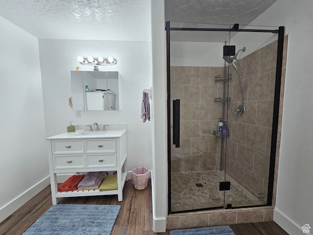 660 S 2500 W, Vernal, UT 84078 - bathroom with hardwood / wood-style flooring, vanity, an enclosed shower, and a textured ceiling