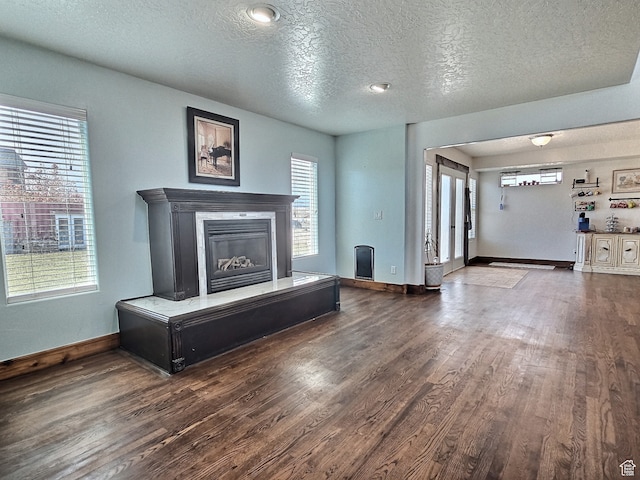 660 S 2500 W, Vernal, UT 84078 - unfurnished living room featuring a healthy amount of sunlight, wood-type flooring, and a textured ceiling