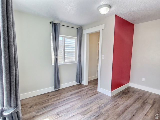 660 S 2500 W, Vernal, UT 84078 - unfurnished bedroom featuring light hardwood / wood-style floors and a textured ceiling