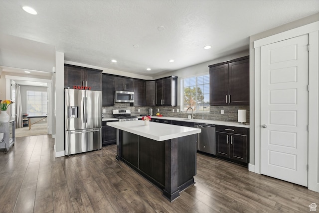 11959 S 235 E, Draper, UT 84020 - kitchen with stainless steel appliances, a sink, decorative backsplash, light countertops, and recessed lighting