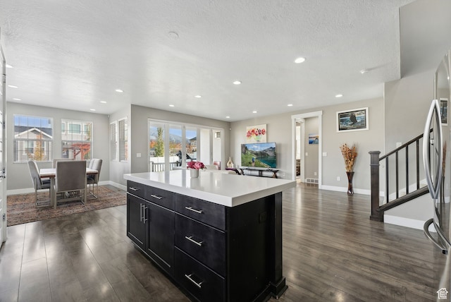 11959 S 235 E, Draper, UT 84020 - kitchen featuring dark cabinetry, dark wood finished floors, light countertops, a textured ceiling, and baseboards