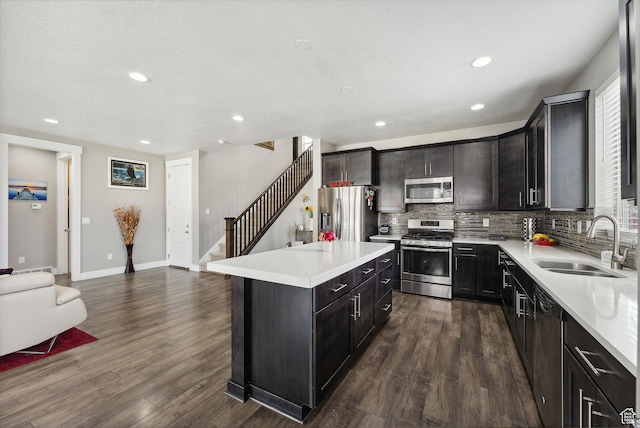 11959 S 235 E, Draper, UT 84020 - kitchen featuring stainless steel appliances, a sink, open floor plan, decorative backsplash, and recessed lighting