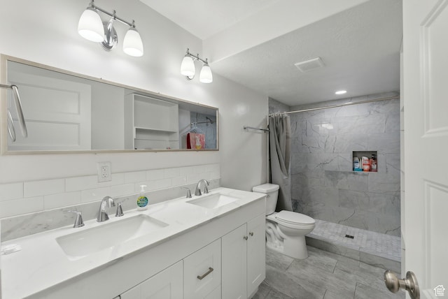 11959 S 235 E, Draper, UT 84020 - bathroom with tiled shower, toilet, double vanity, and decorative backsplash