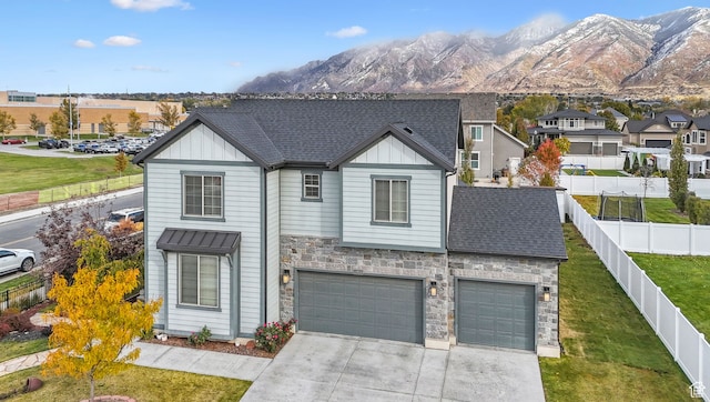 11959 S 235 E, Draper, UT 84020 - view of front of property featuring board and batten siding, stone siding, driveway, and a garage