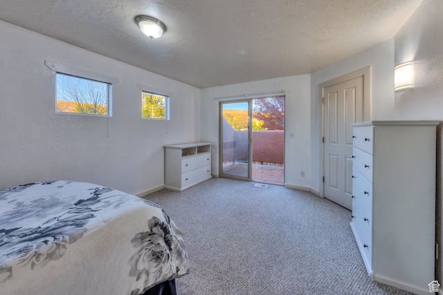 385 E Pueblo Ct, Moab, UT 84532 - carpeted bedroom with a textured ceiling and access to outside