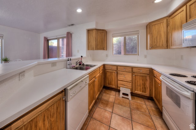 385 E Pueblo Ct, Moab, UT 84532 - kitchen featuring light tile patterned floors, white appliances, sink, and kitchen peninsula