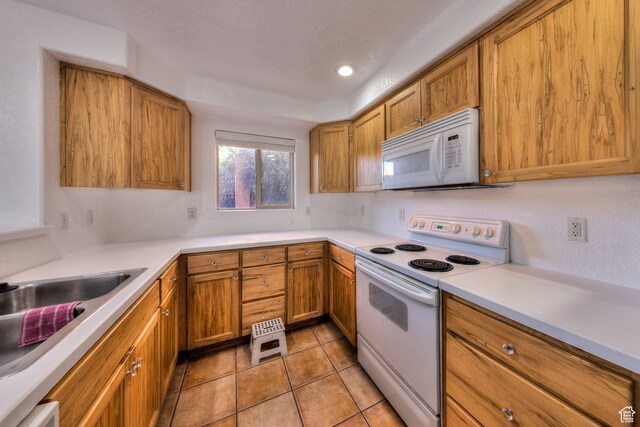 385 E Pueblo Ct, Moab, UT 84532 - kitchen with range with electric stovetop, light tile patterned floors, and sink