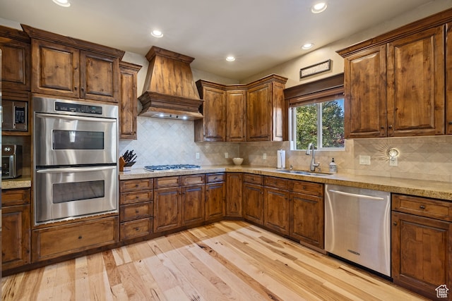 2745 E 4510 S, Holladay, UT 84117 - kitchen featuring sink, appliances with stainless steel finishes, tasteful backsplash, custom range hood, and light wood-type flooring