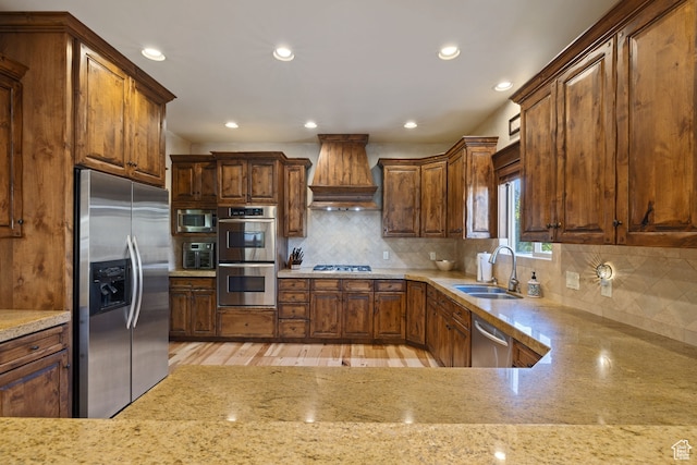 2745 E 4510 S, Holladay, UT 84117 - kitchen featuring sink, light stone countertops, light wood-type flooring, appliances with stainless steel finishes, and premium range hood