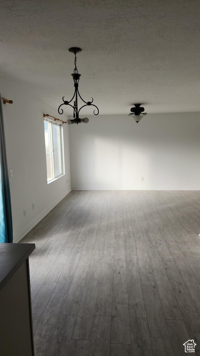 449 N 400 W, Heber City, UT 84032 - unfurnished room with a textured ceiling, light hardwood / wood-style flooring, and a notable chandelier