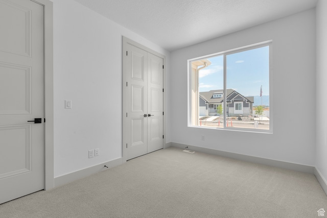 2523 N 3250 W, Clinton, UT 84015 - unfurnished bedroom featuring light colored carpet and a textured ceiling