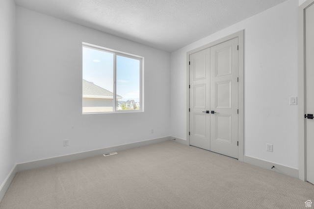 2523 N 3250 W, Clinton, UT 84015 - unfurnished bedroom featuring a textured ceiling and light carpet