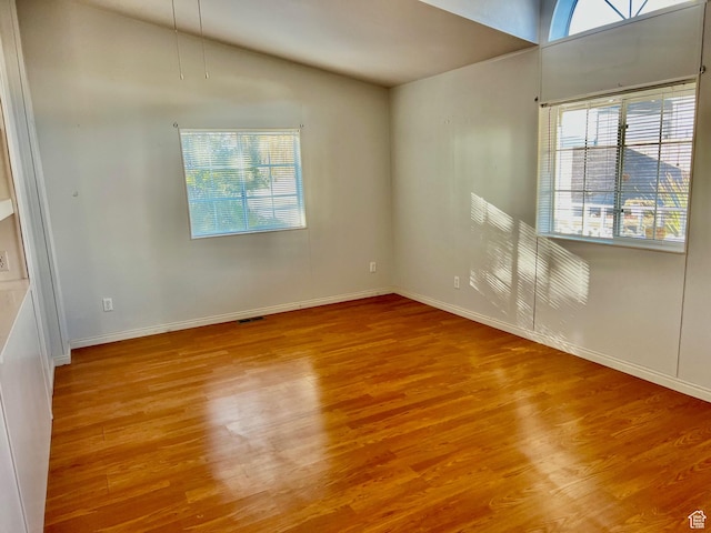 1360 N Dixie Downs Rd Unit 55, St George, UT 84770 - empty room with healthy amount of natural light, wood finished floors, baseboards, and vaulted ceiling