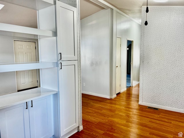 1360 N Dixie Downs Rd Unit 55, St George, UT 84770 - hallway featuring wallpapered walls, wood finished floors, baseboards, and ornamental molding
