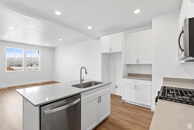 1084 E 1930 S Unit 423, Heber City, UT 84032 - kitchen with sink, white cabinetry, light hardwood / wood-style flooring, a center island with sink, and stainless steel appliances
