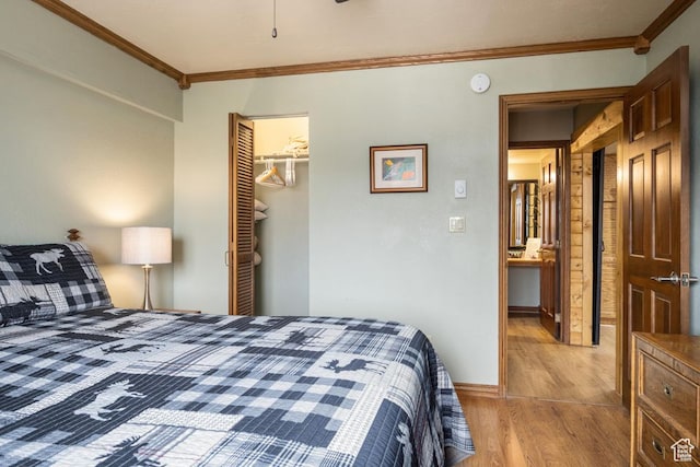 150 W Ridgeview St Unit 220, Brian Head, UT 84719 - bedroom featuring a spacious closet, a closet, light hardwood / wood-style flooring, and crown molding
