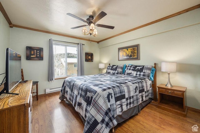 150 W Ridgeview St Unit 220, Brian Head, UT 84719 - bedroom with a baseboard heating unit, wood finished floors, ornamental molding, baseboards, and a ceiling fan
