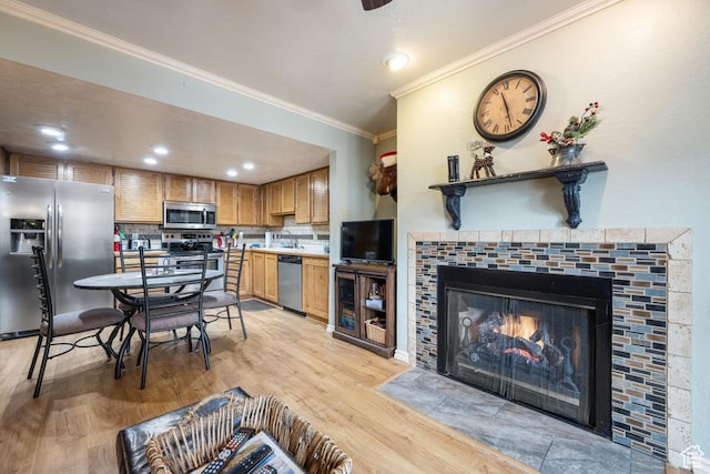 150 W Ridgeview St Unit 220, Brian Head, UT 84719 - kitchen featuring appliances with stainless steel finishes, ornamental molding, a fireplace, light wood-type flooring, and decorative backsplash
