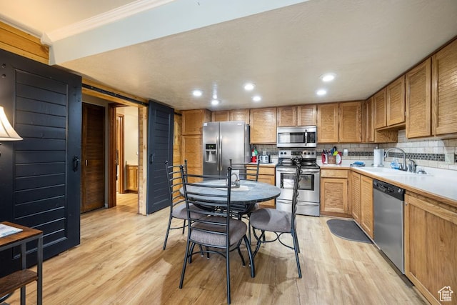 150 W Ridgeview St Unit 220, Brian Head, UT 84719 - kitchen with stainless steel appliances, sink, light wood-type flooring, and ornamental molding