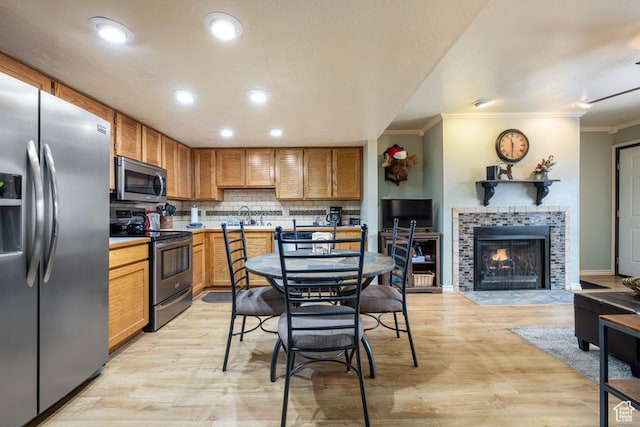 150 W Ridgeview St Unit 220, Brian Head, UT 84719 - kitchen with light hardwood / wood-style floors, sink, tasteful backsplash, crown molding, and appliances with stainless steel finishes