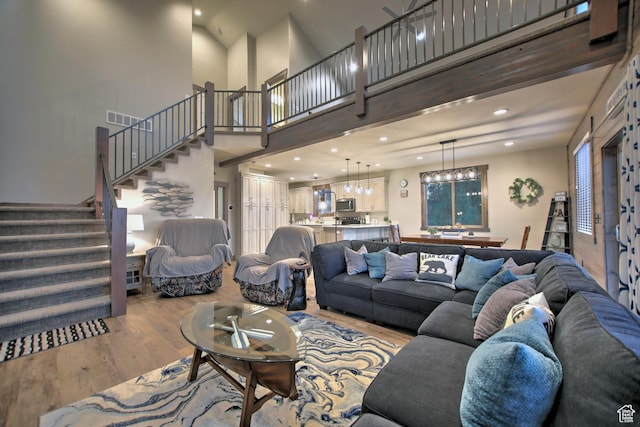 1400 N Cisco Cir, Garden City, UT 84028 - living area with wood finished floors, stairs, a towering ceiling, recessed lighting, and a chandelier
