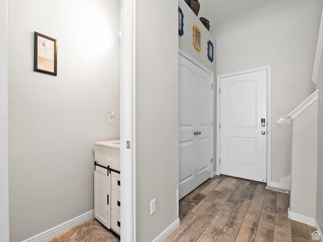 4182 E Paddock Way, Eagle Mountain, UT 84005 - hallway featuring a barn door and hardwood / wood-style floors