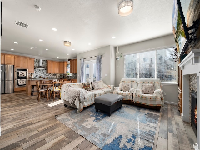 4182 E Paddock Way, Eagle Mountain, UT 84005 - living room with a stone fireplace and hardwood / wood-style floors