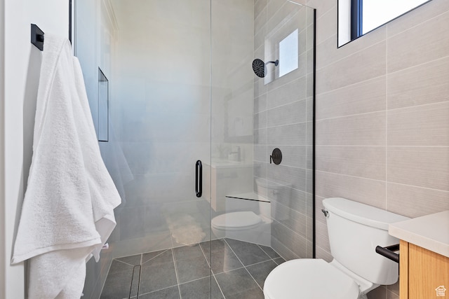 3967 N Hillside Way, Santa Clara, UT 84765 - bathroom featuring tile walls, a shower with door, vanity, tile patterned flooring, and toilet