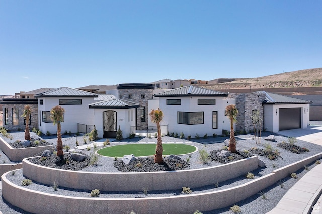 3967 N Hillside Way, Santa Clara, UT 84765 - contemporary home with a standing seam roof, stone siding, driveway, and metal roof