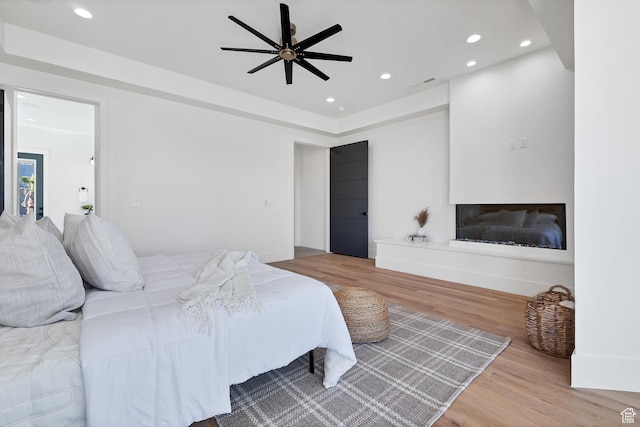 3967 N Hillside Way, Santa Clara, UT 84765 - bedroom featuring wood finished floors, recessed lighting, a glass covered fireplace, and baseboards