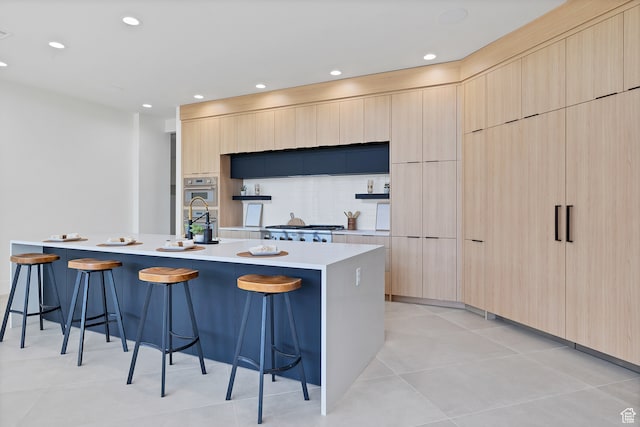 3967 N Hillside Way, Santa Clara, UT 84765 - kitchen featuring a spacious island, a kitchen bar, light brown cabinetry, and light tile patterned floors