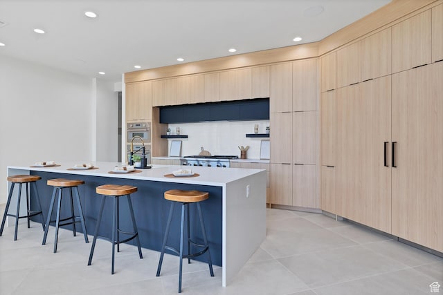 3967 N Hillside Way, Santa Clara, UT 84765 - kitchen featuring modern cabinets, light brown cabinets, a breakfast bar area, light countertops, and recessed lighting