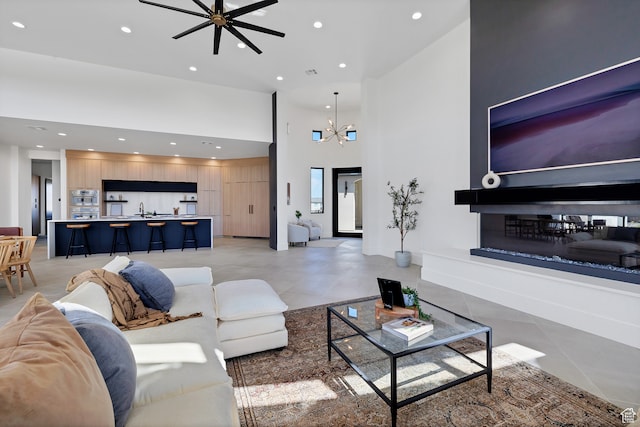 3967 N Hillside Way, Santa Clara, UT 84765 - living room with ceiling fan with notable chandelier, sink, light tile patterned floors, and a towering ceiling