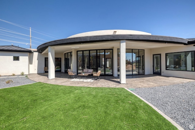 3967 N Hillside Way, Santa Clara, UT 84765 - back of house with a patio, an outdoor living space, a standing seam roof, a lawn, and stucco siding
