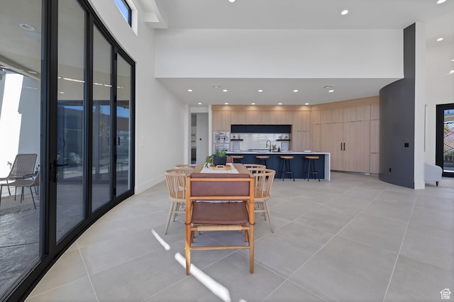3967 N Hillside Way, Santa Clara, UT 84765 - dining room featuring a towering ceiling, sink, and light tile patterned floors