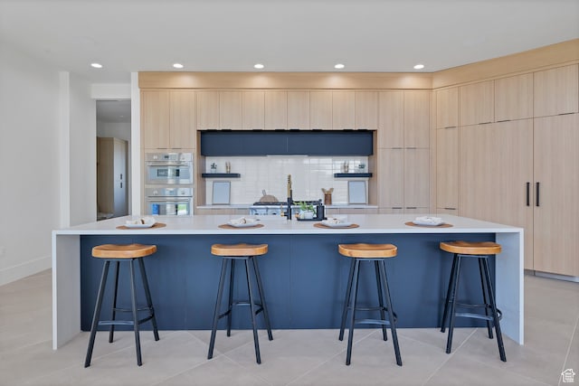 3967 N Hillside Way, Santa Clara, UT 84765 - kitchen featuring a kitchen breakfast bar, a spacious island, and decorative backsplash