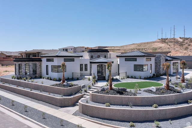 3967 N Hillside Way, Santa Clara, UT 84765 - contemporary home with a standing seam roof, metal roof, stucco siding, a mountain view, and stone siding