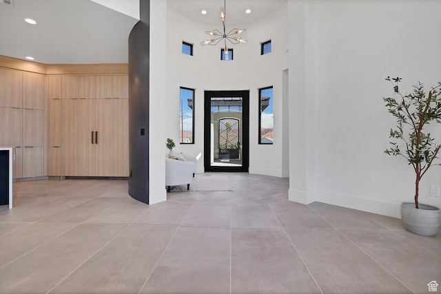 3967 N Hillside Way, Santa Clara, UT 84765 - foyer featuring a towering ceiling, light tile patterned flooring, and an inviting chandelier