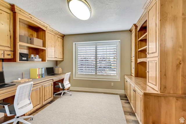 158 E Shepard Ln, Kaysville, UT 84037 - home office featuring light hardwood / wood-style floors, built in desk, and a textured ceiling