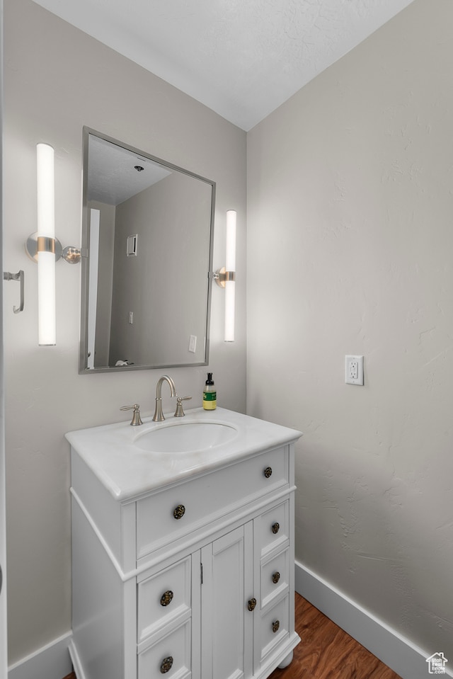 44 W Broadway S Unit 1205S, Salt Lake City, UT 84101 - bathroom featuring a textured ceiling, vanity, and hardwood / wood-style flooring