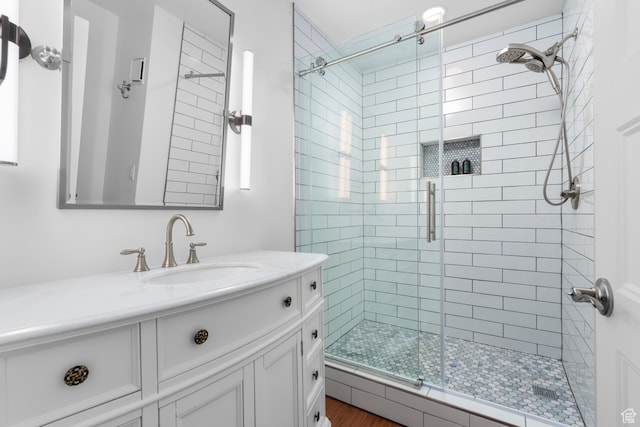 44 W Broadway S Unit 1205S, Salt Lake City, UT 84101 - bathroom with hardwood / wood-style floors, vanity, and a shower with shower door
