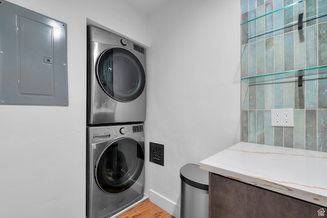 44 W Broadway S Unit 1205S, Salt Lake City, UT 84101 - laundry room with electric panel, stacked washer / drying machine, and light wood-type flooring