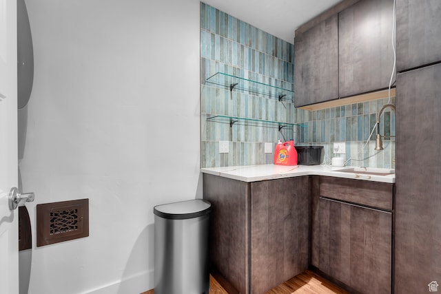 44 W Broadway S Unit 1205S, Salt Lake City, UT 84101 - bathroom with hardwood / wood-style floors, decorative backsplash, and vanity