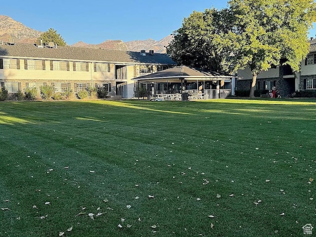view of home's community featuring a yard and a mountain view