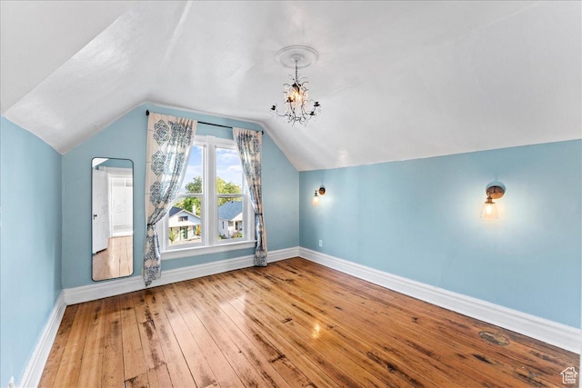673 E 7th Ave, Salt Lake City, UT 84103 - additional living space featuring baseboards, hardwood / wood-style flooring, vaulted ceiling, and a chandelier