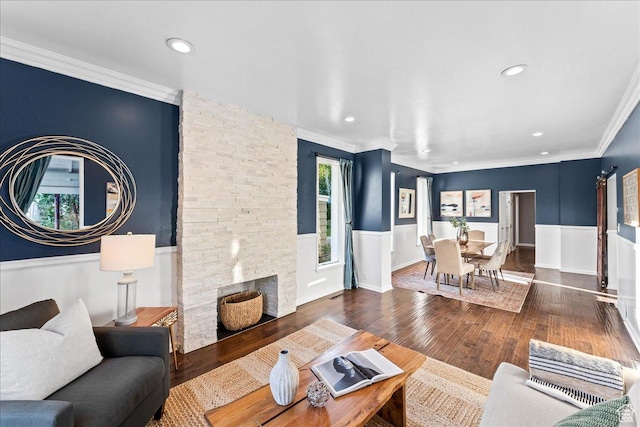 673 E 7th Ave, Salt Lake City, UT 84103 - living area featuring wainscoting, wood finished floors, ornamental molding, recessed lighting, and a stone fireplace