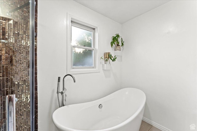 673 E 7th Ave, Salt Lake City, UT 84103 - full bath featuring a soaking tub, baseboards, and a shower stall