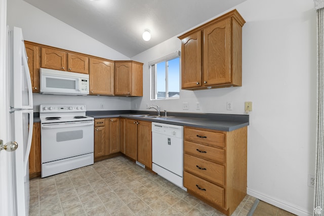 kitchen featuring sink, white appliances, and vaulted ceiling