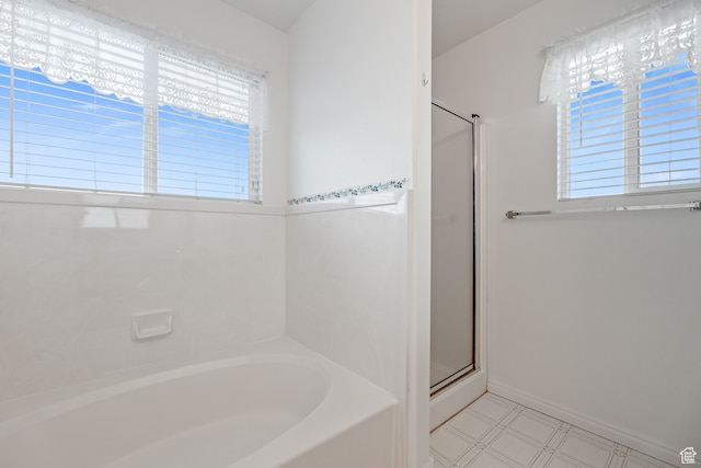 bathroom featuring independent shower and bath