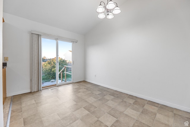 spare room with lofted ceiling and a notable chandelier